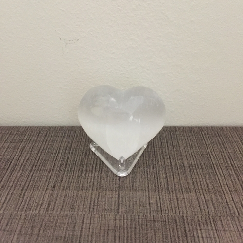 A heart-shaped selenite crystal representing love and purity